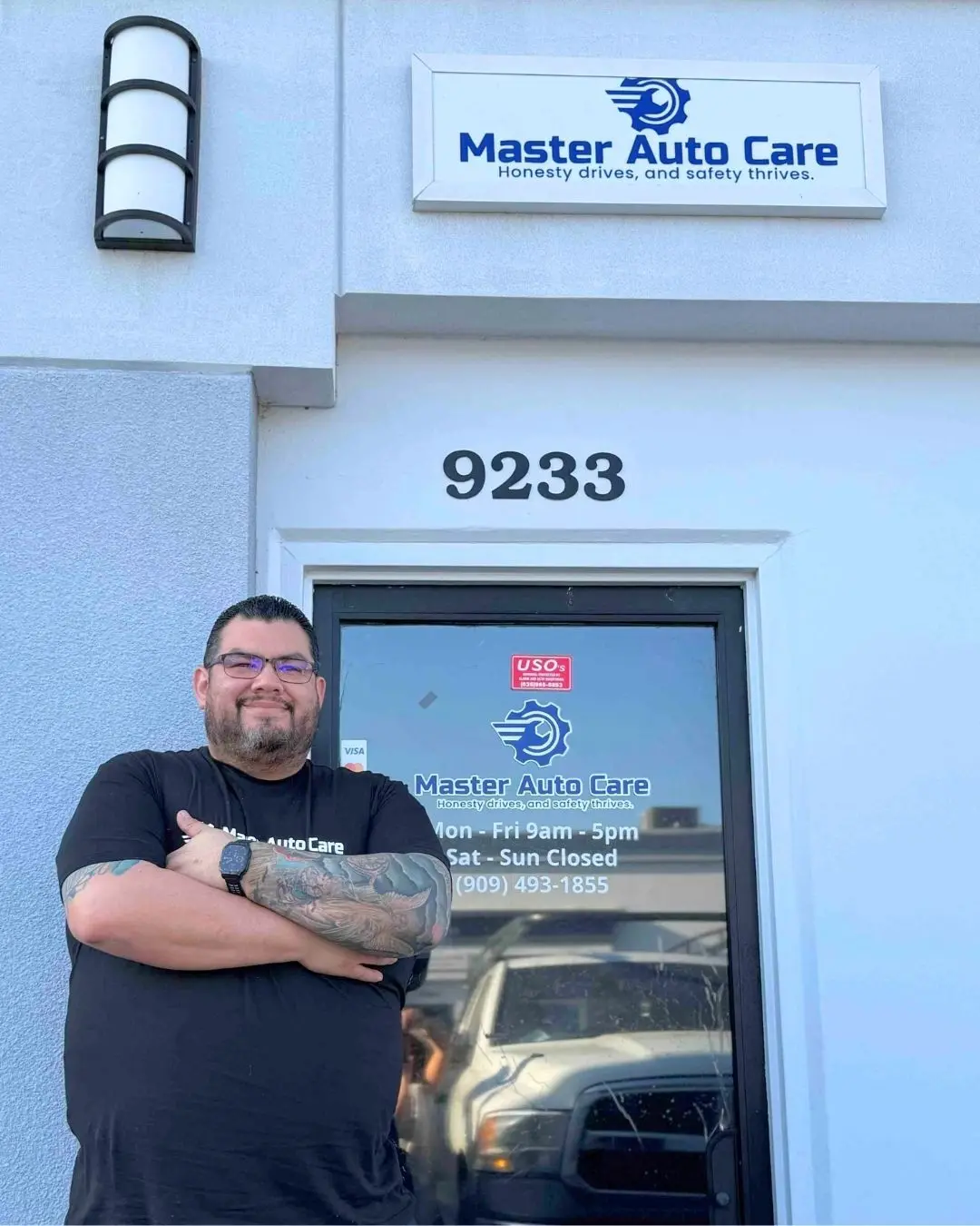 Oscar Gomez standing with arms crossed at the Master Auto Care front door, 9233 Archibald Ave